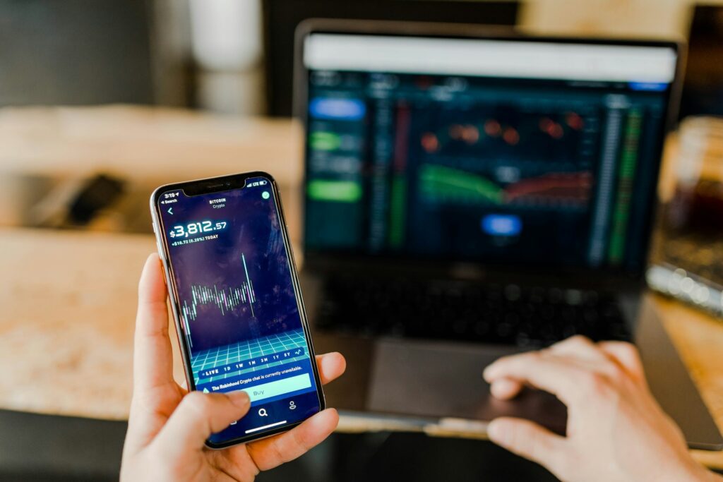phone and laptop man investing