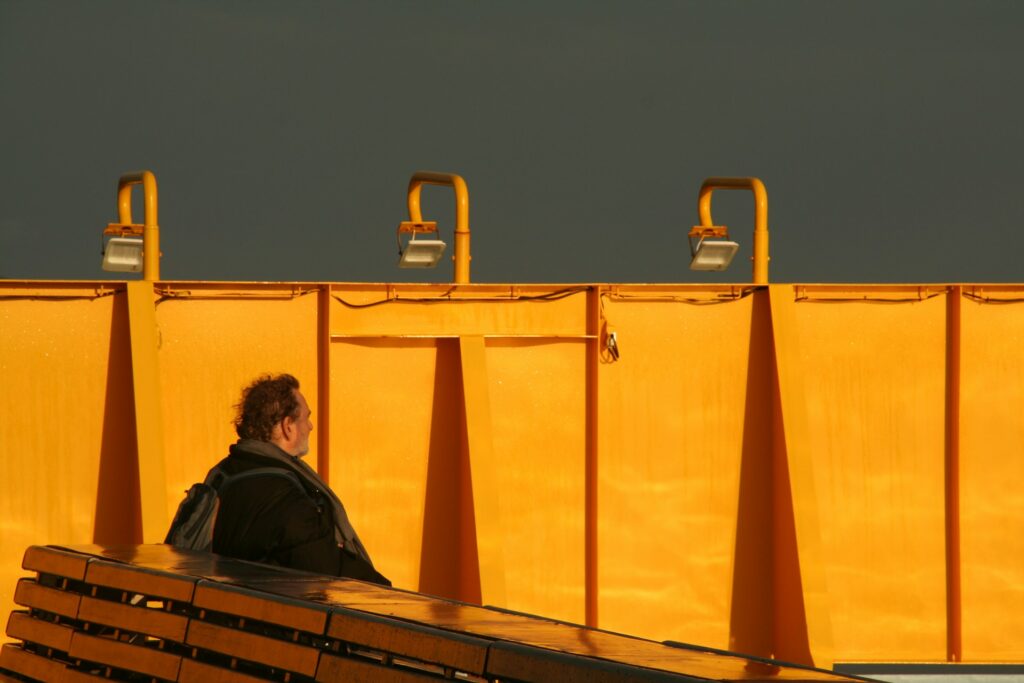 man sat on yellow bridge