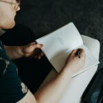 man journaling on knee