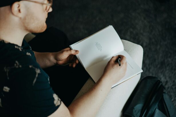 man journaling on knee
