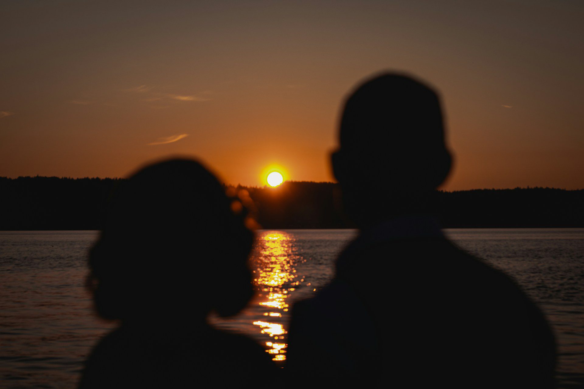 man and woman at sunset