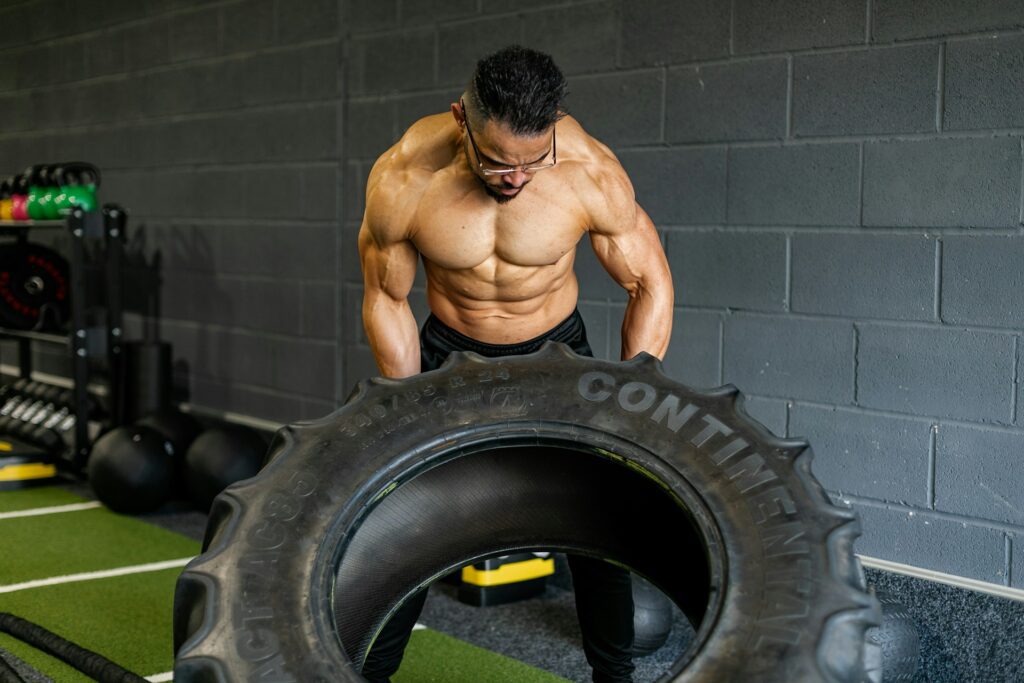man flipping tyre