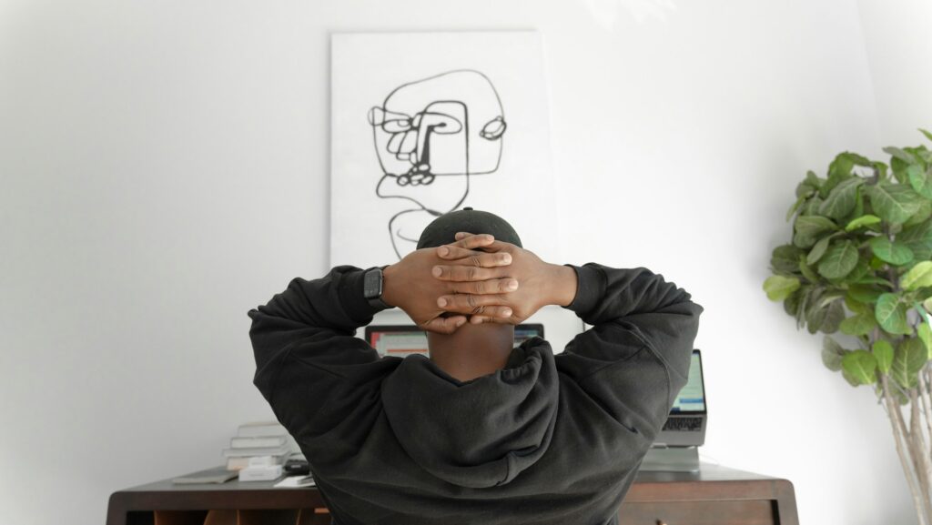 man at desk thinking on computer