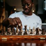 man playing chess on table
