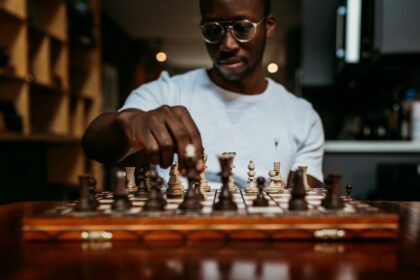 man playing chess on table