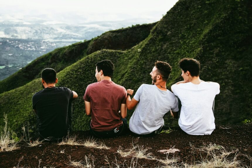 men on hill listening