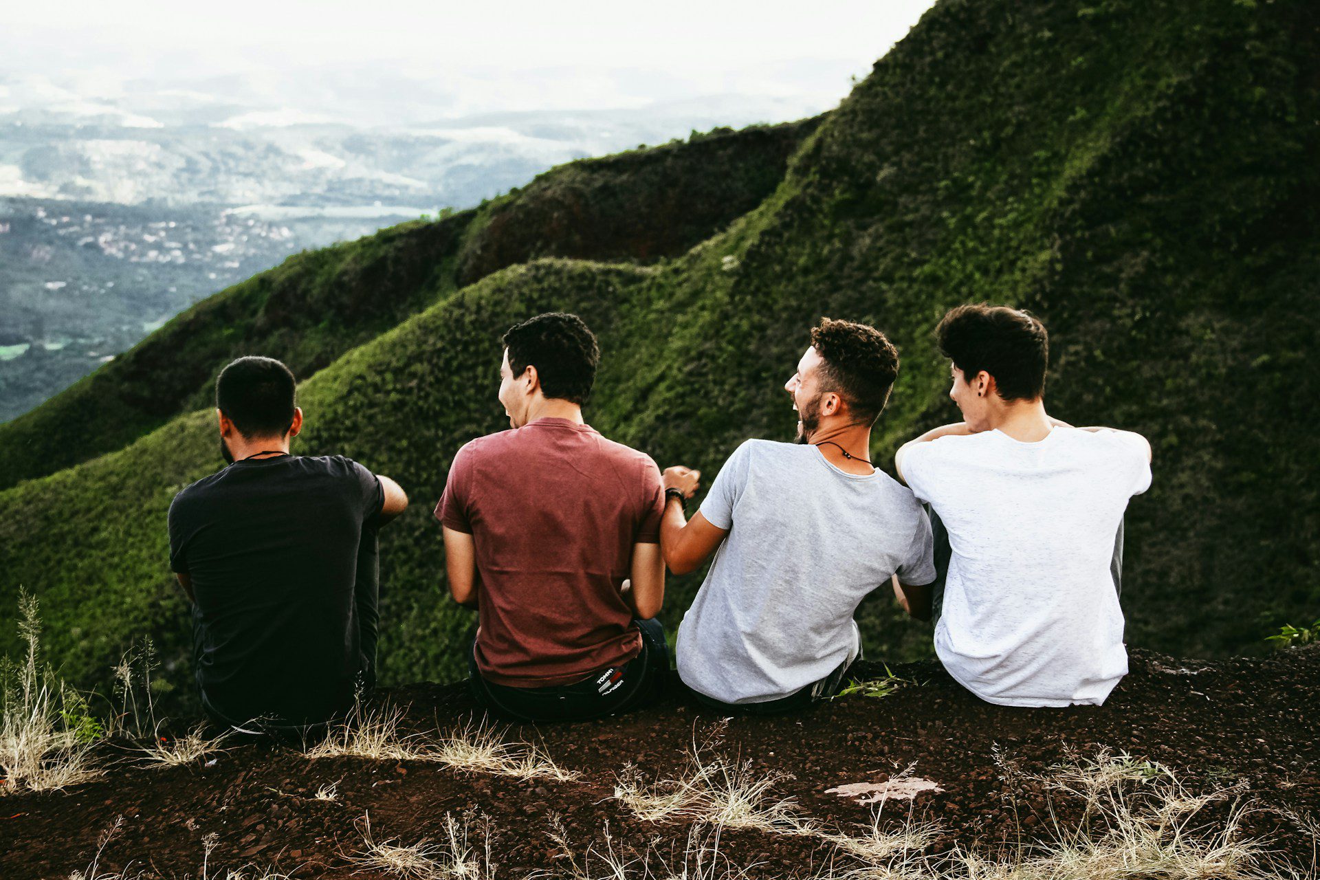 men on hill listening