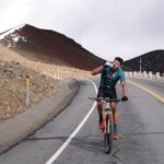 man riding bike hard in mountains
