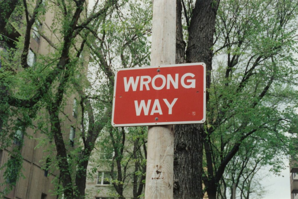 wrong way sign on pole