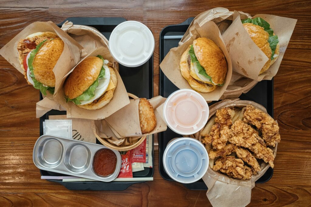 Overeating burgers on a table