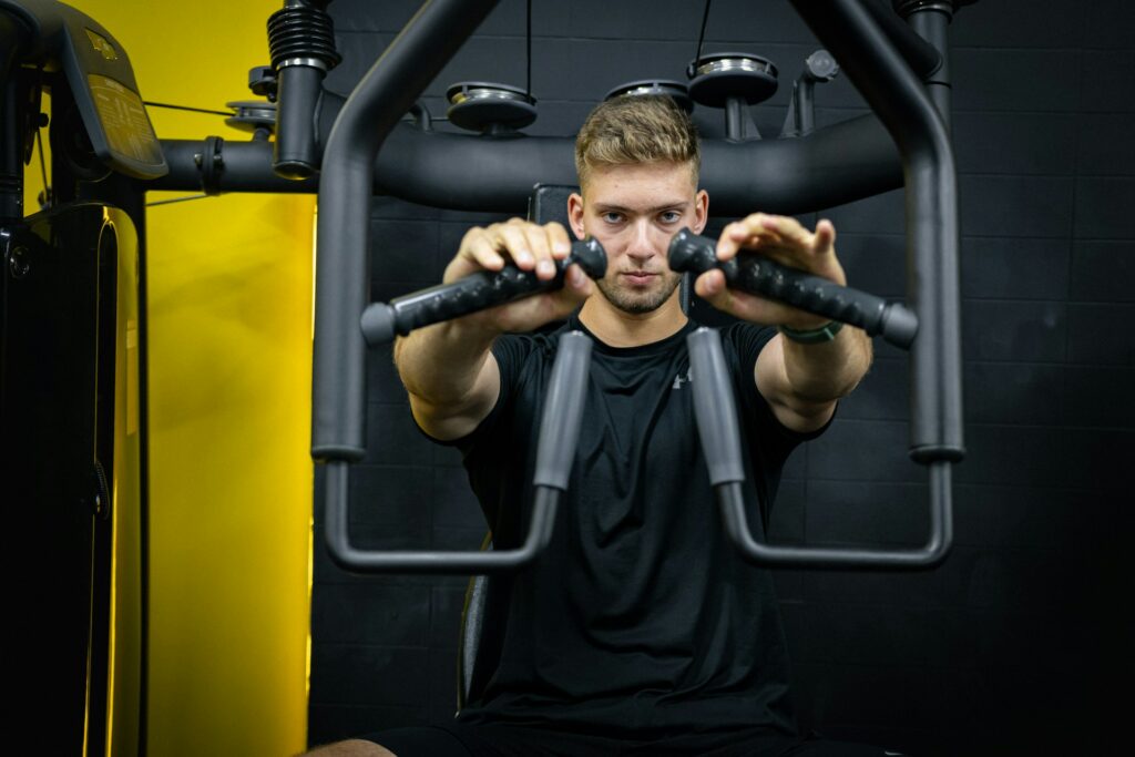 man working out on pec machine