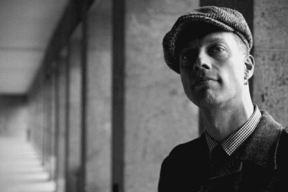 man with flat cap in alley